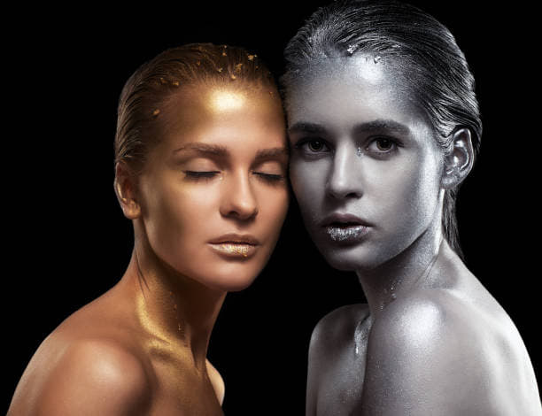 Beauty portrait of young gorgeous women. Golden and silver girls on black background.